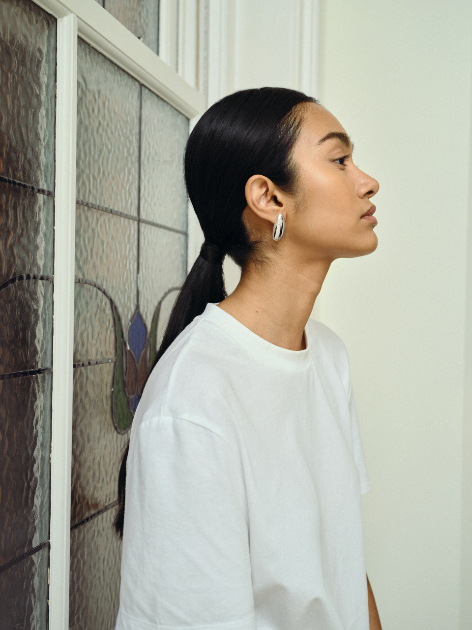 Model wears sterling silver sculptural earrings.